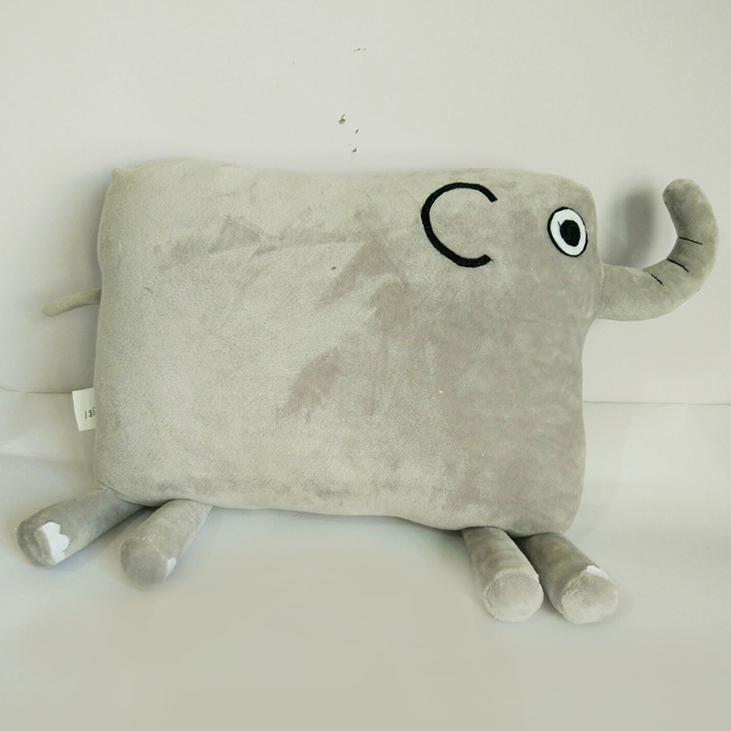 Select to view 'Grey rectangular Leo the Elephant plush pillow lying flat, showcasing soft microfiber fabric, embroidered facial features, and tail design.' image